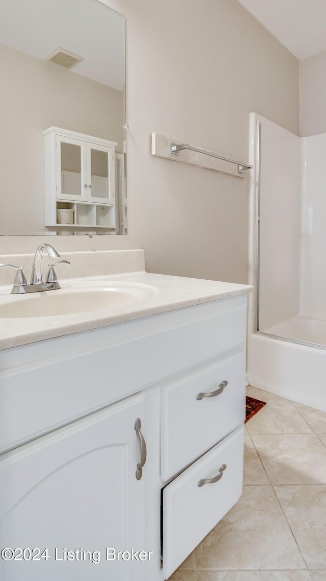 bathroom with vanity, tile patterned floors, and bath / shower combo with glass door