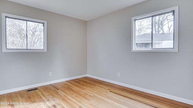 empty room with hardwood / wood-style floors