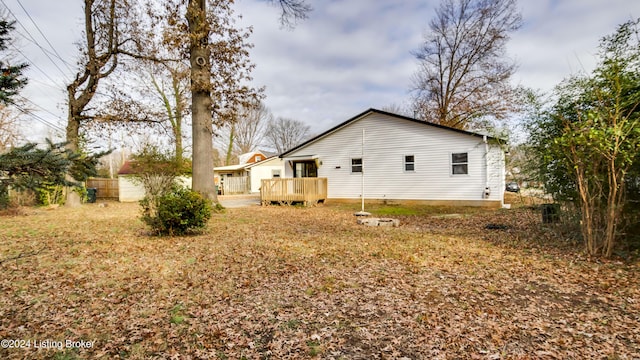 rear view of property featuring a wooden deck