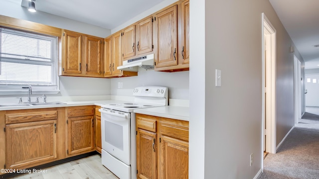 kitchen featuring light wood-type flooring, white range with electric cooktop, and sink