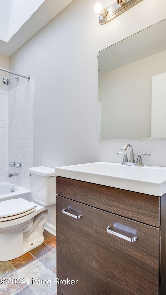 full bathroom with toilet, vanity, and tiled shower / bath combo