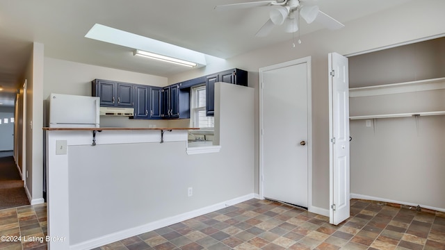 kitchen with ceiling fan and blue cabinets