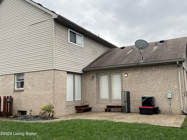 rear view of property featuring a lawn