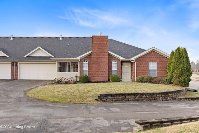 single story home with a front lawn and a garage