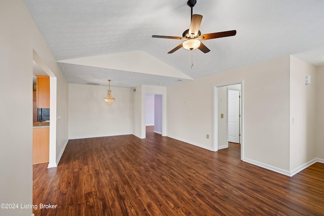 unfurnished living room featuring lofted ceiling, ceiling fan, a textured ceiling, and dark hardwood / wood-style floors