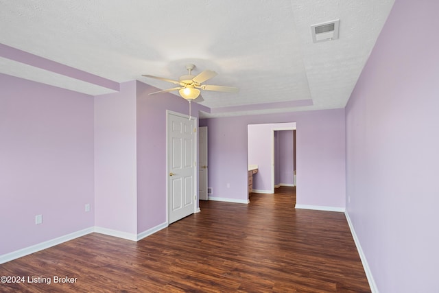 unfurnished room featuring a textured ceiling, dark hardwood / wood-style floors, and ceiling fan