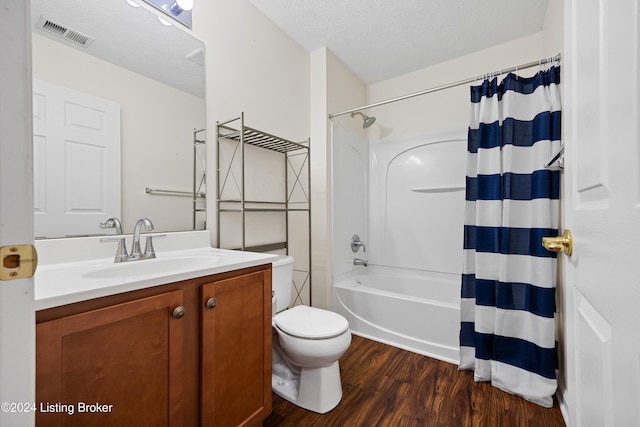 full bathroom with a textured ceiling, toilet, vanity, shower / tub combo, and hardwood / wood-style flooring