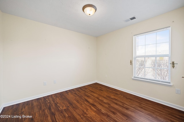 unfurnished room with wood-type flooring