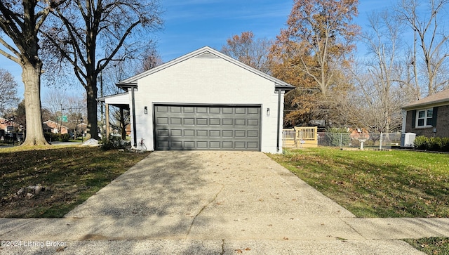 view of side of home featuring a garage, an outdoor structure, and a lawn