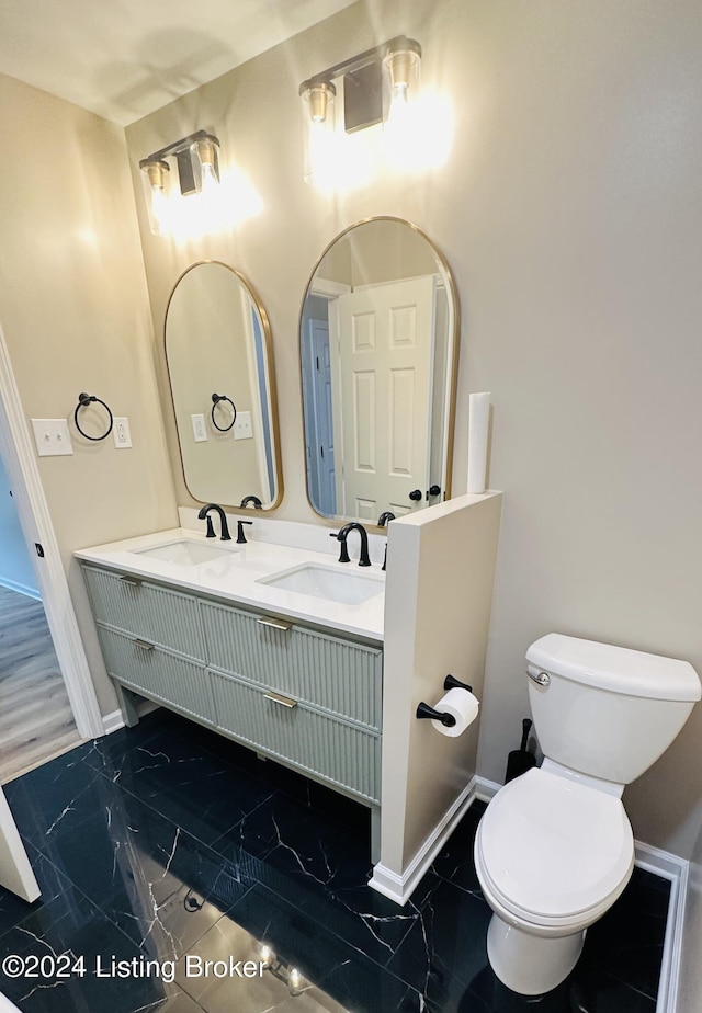 bathroom featuring vanity and toilet