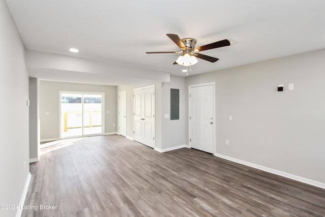 empty room with ceiling fan, dark hardwood / wood-style flooring, and electric panel