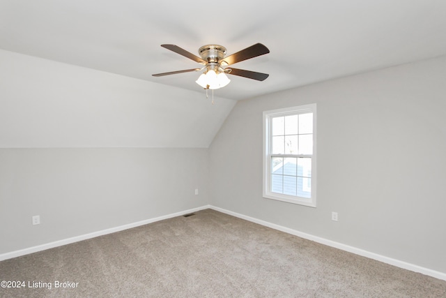 additional living space featuring carpet flooring, ceiling fan, and vaulted ceiling