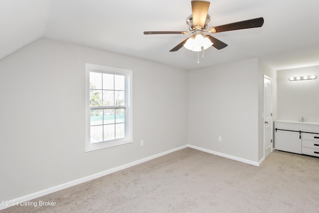 unfurnished bedroom featuring ceiling fan, light carpet, and lofted ceiling