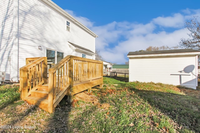 rear view of property featuring a wooden deck