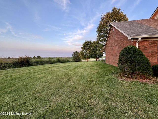 yard at dusk with a rural view