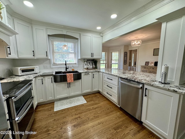 kitchen with white cabinets, stainless steel appliances, and sink