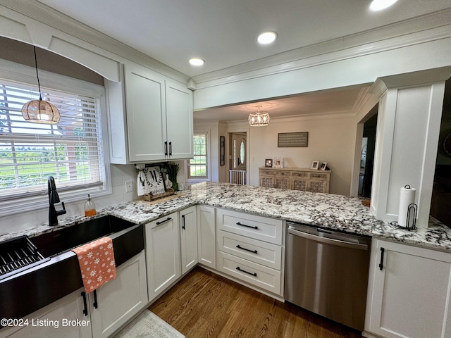 kitchen with stainless steel dishwasher, white cabinets, hanging light fixtures, and a wealth of natural light