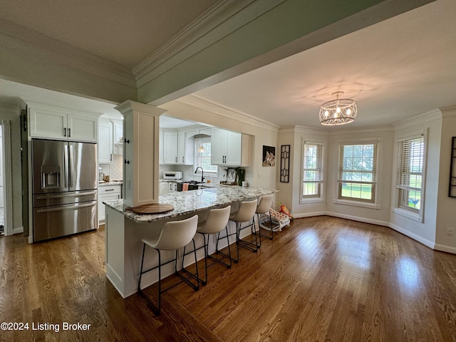 kitchen with sink, white cabinets, dark wood-type flooring, and stainless steel refrigerator with ice dispenser