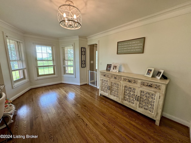 interior space featuring a chandelier, dark hardwood / wood-style floors, and crown molding