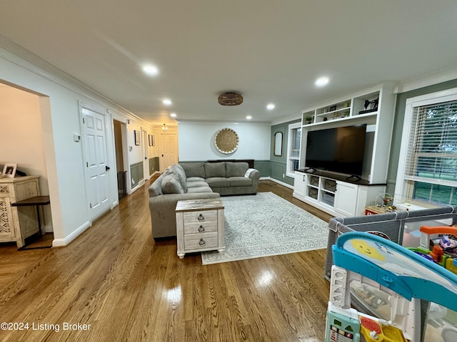 living room featuring dark hardwood / wood-style floors and crown molding