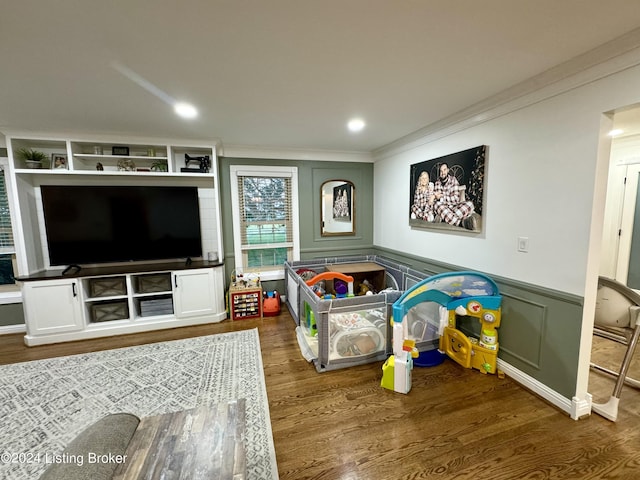 recreation room featuring dark hardwood / wood-style flooring and ornamental molding