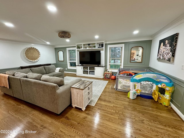 living room with hardwood / wood-style floors and ornamental molding