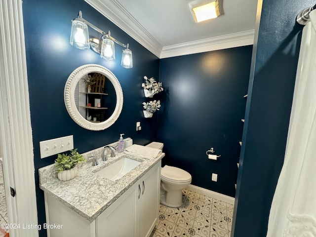 bathroom featuring toilet, vanity, and ornamental molding