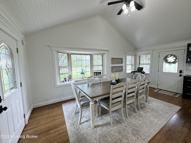 dining area with ceiling fan, dark hardwood / wood-style flooring, and vaulted ceiling