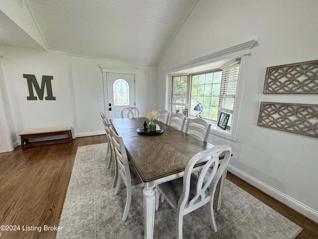 dining space with vaulted ceiling and dark wood-type flooring