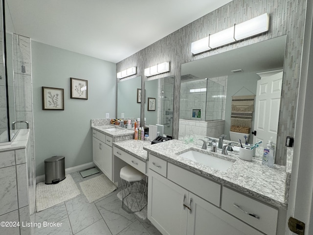 bathroom with vanity and shower with separate bathtub