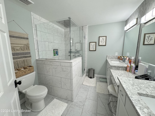 bathroom featuring toilet, vanity, and tiled shower