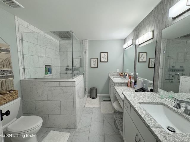 bathroom featuring vanity, an enclosed shower, and toilet