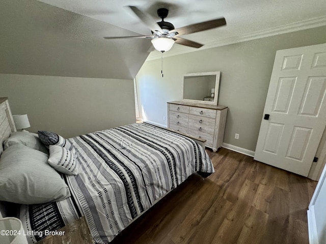 bedroom with ceiling fan, dark hardwood / wood-style floors, a textured ceiling, and vaulted ceiling