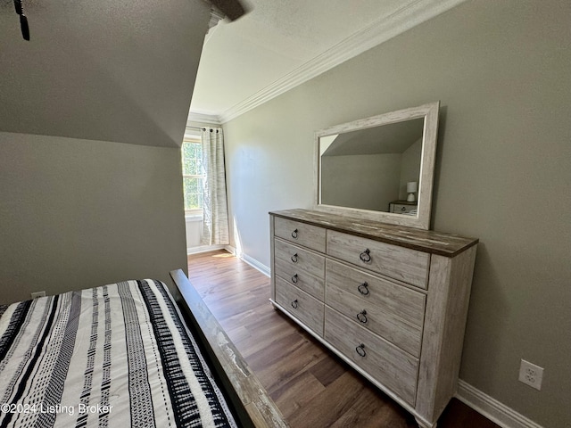 bedroom with a textured ceiling, light wood-type flooring, and crown molding