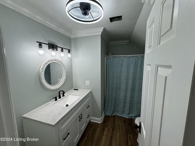 bathroom with vanity, vaulted ceiling, ceiling fan, crown molding, and hardwood / wood-style flooring