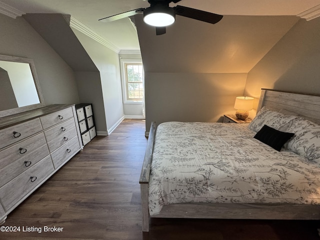 bedroom with dark hardwood / wood-style floors, vaulted ceiling, ceiling fan, and crown molding