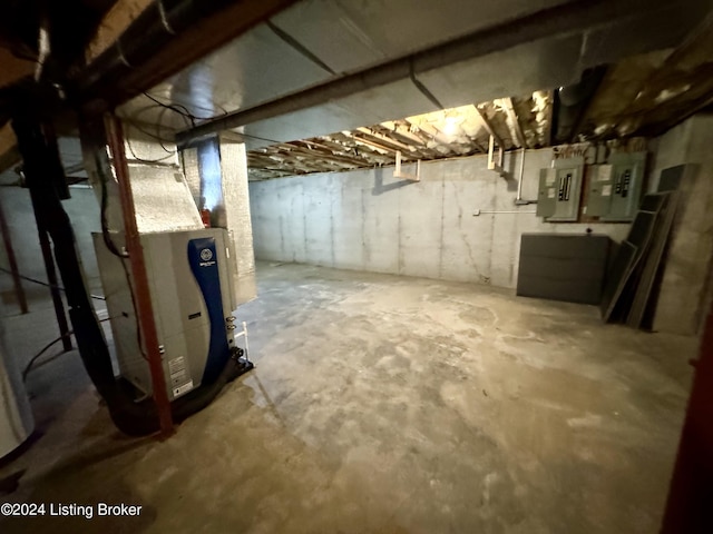 basement featuring electric panel and heating unit