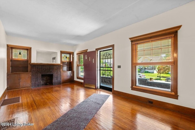 unfurnished living room with light wood-type flooring and a fireplace