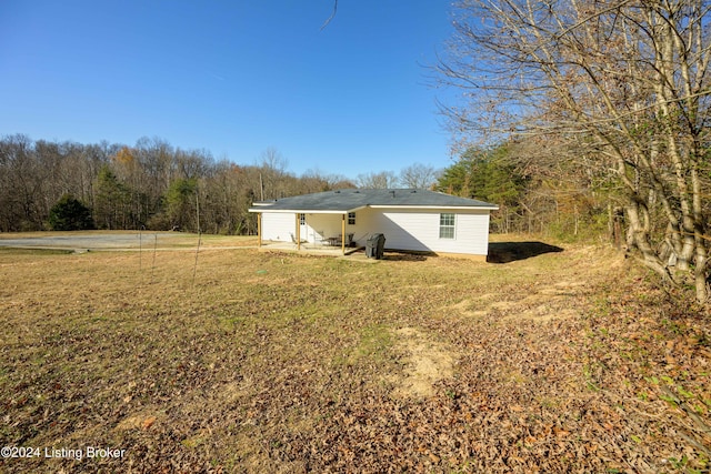 rear view of house with a lawn and a patio area