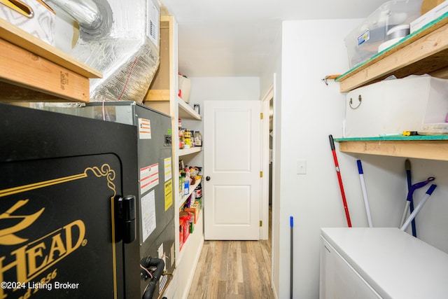 washroom featuring separate washer and dryer and light hardwood / wood-style floors