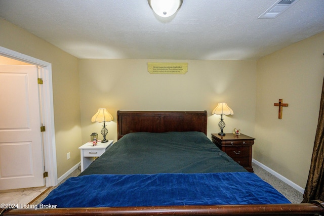 bedroom with carpet flooring and a textured ceiling