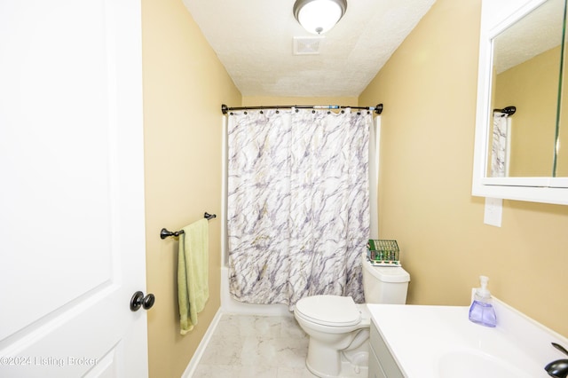 bathroom featuring vanity, toilet, and a textured ceiling