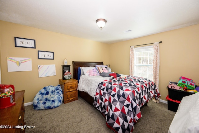 bedroom with dark colored carpet