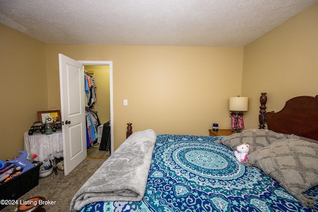 bedroom featuring a textured ceiling and carpet floors