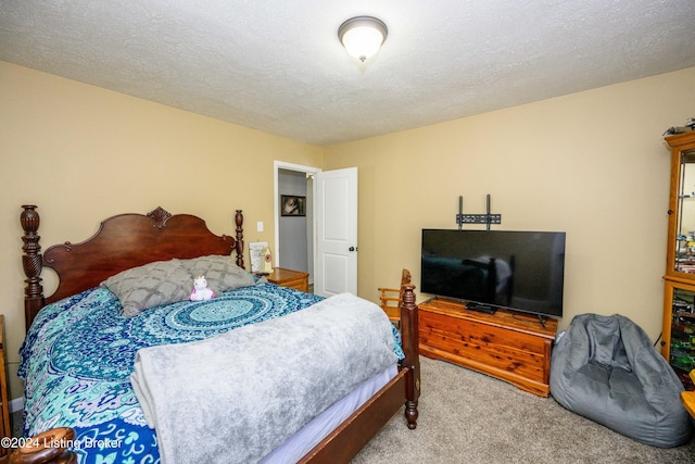 carpeted bedroom with a textured ceiling