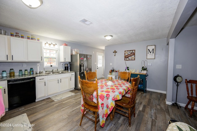 dining space featuring dark hardwood / wood-style flooring, a textured ceiling, and sink