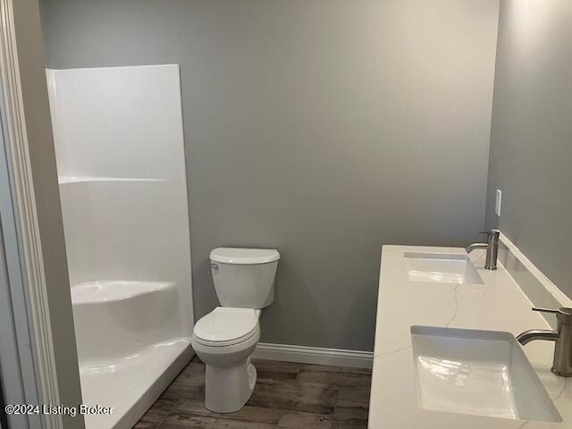 bathroom featuring hardwood / wood-style floors, toilet, and sink