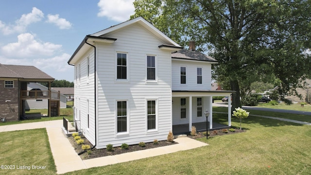 view of front of house with a front yard and a porch