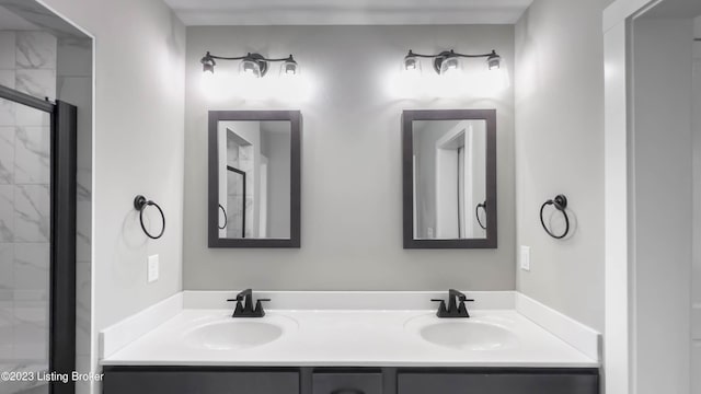 bathroom with vanity and a shower with door