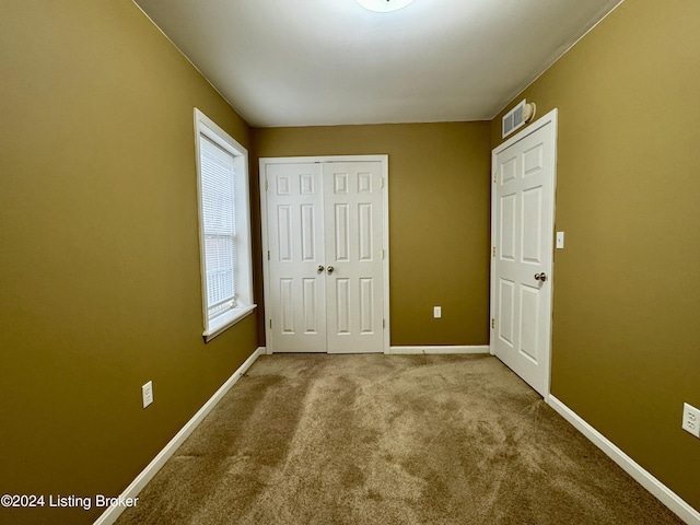 unfurnished bedroom featuring a closet and carpet